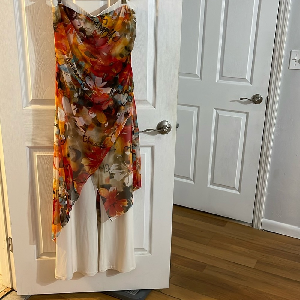 Cache white with print sleeveless jumpsuit comes with a red cardigan